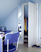 Jugendzimmer unter dem Dach mit hellblauer Wand und offener Tür vom Stauraum
