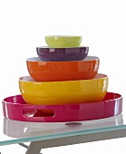 Colourful bowls on a pink tray