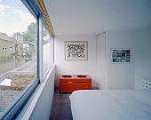 A modern white bedroom with a window bank
