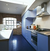 Eine blaue Küche in einer Loftwohnung