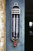 Nahaufnahme eines Thermometers auf blauer Tür