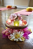 Table decoration with flowers and a tea light in a yoga studio