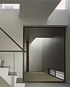 Contemporary staircase with a view into an empty room and a tatami mat on the floor