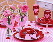 Valentine's Day table decoration of pink ranunculi & hearts