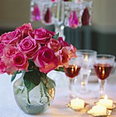 Pink roses, tea lights and glasses