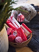 Christmas presents in a basket with a dog on a rug in the background