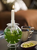 A candle in a candle holder filled with water