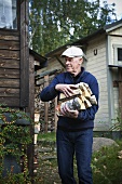 Older man carrying firewood