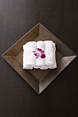 Rolled up towels and orchids