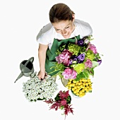 A gardner with various cut flowers