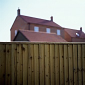 A wooden fence in front of a house