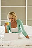 Woman on bed with laptop