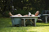 Man in outdoor bathtub