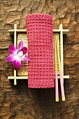 Table accessories: hand towel, chopsticks, bamboo mat & orchid