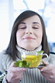 Young woman with lemon and mint tea