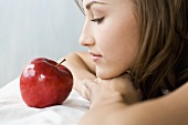 Young woman with a red apple