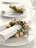 Napkin wreaths of roses and baby's breath