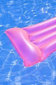 Pink air bed in water