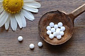 Homeopathic remedy (globuli) and chamomile flower