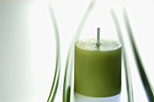 A green candle and papryus sedge stalks