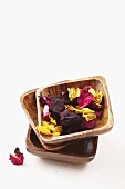 Dried rose petals in wooden bowls