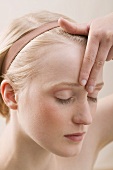 Young, blond woman doing relaxation exercise