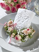 Romantic place-setting with napkin and flower wreath