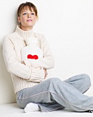 Woman with hot-water bottle