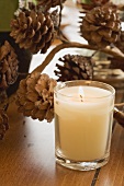 Christmas table decoration: candle and pine cones