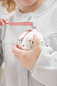 Small girl holding Christmas bauble
