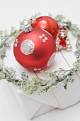 Christmas tree ornaments and wreath on Christmas parcel