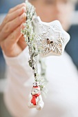 Woman holding Christmas tree ornaments