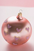 Pink Christmas bauble with painted hearts