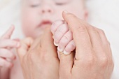 Hands holding a baby