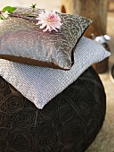 Three different cushions with a flower
