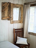 Mirror with wooden frame in rustic bedroom