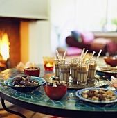 Coffee and snacks on table in front of fire