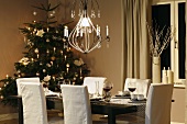Laid table and Christmas tree in dining room