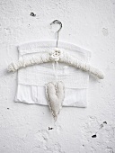 Clothes hanger with a heart hanging on a wall