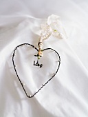 Heart shape with 'love' written on white fabric