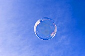 Soap bubble in front of a blue sky