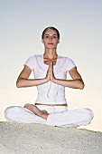 Germany, Bavaria, Woman exercising yoga