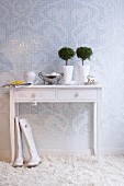White console table on deep-pile carpet against mosaic wall