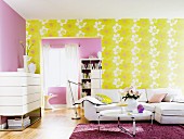 Living room with white furniture, lilac wall and yellow wallpaper with large floral pattern