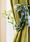 Hand-crafted curtain tie-back made from marbles and scraps of fabric