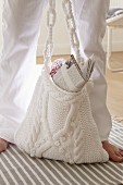 A white kitted shoulder bag with slubs and a braided pattern