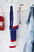 A knitted scarf hanging on a hook