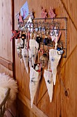 An advent calendar made from fabric bags hanging on a row of hooks