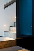 Detail of a staircase with a landing and black lacquered closet