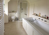 Daylight bathroom with bathtub, shower cubicle and toilet
